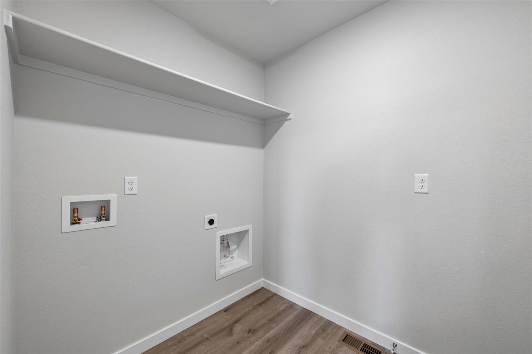 A white wall with pictures on it.