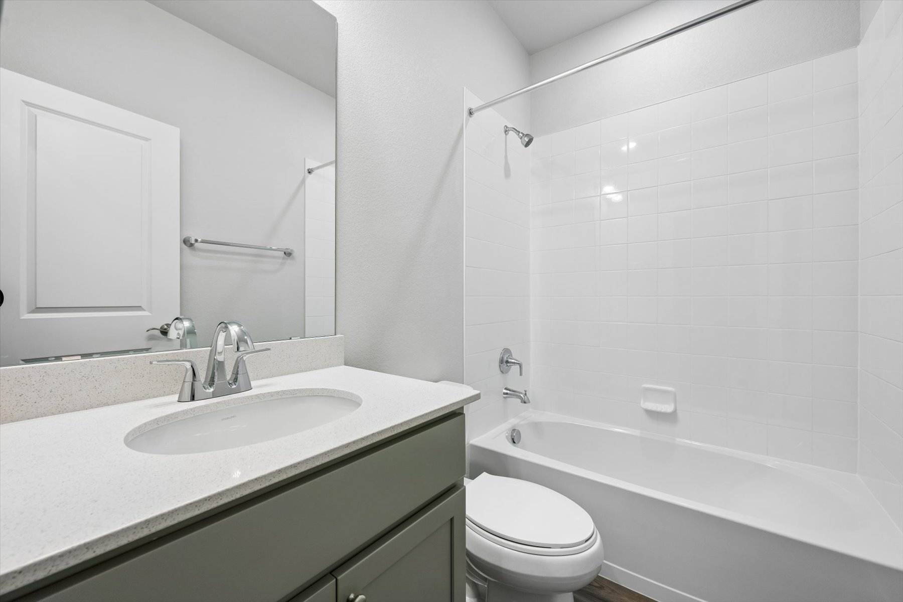 A bathroom with a tub sink and toilet.
