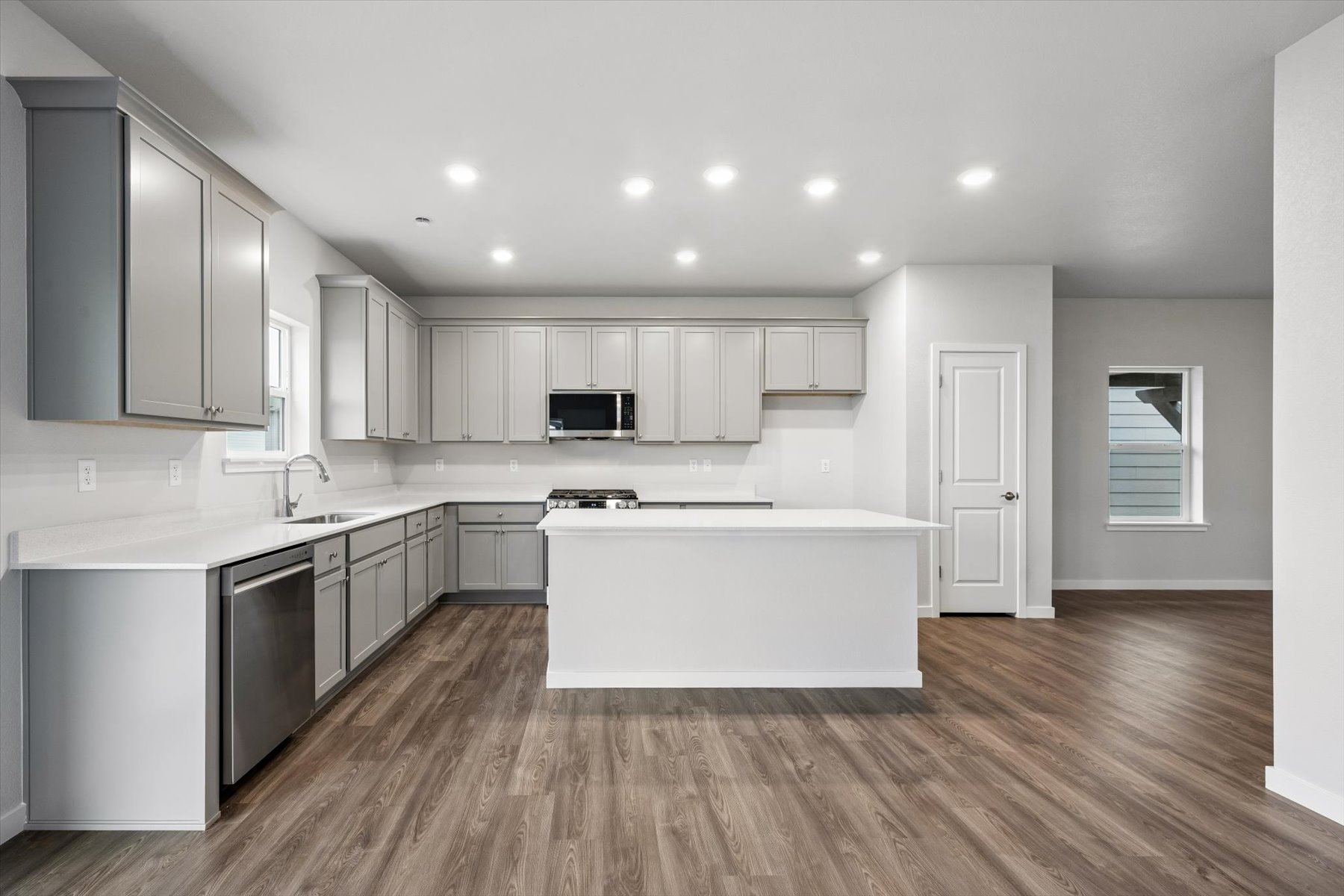 A kitchen with white cabinets.