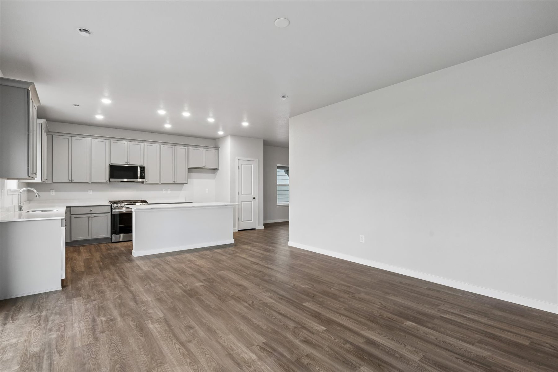 A large kitchen with white cabinets.