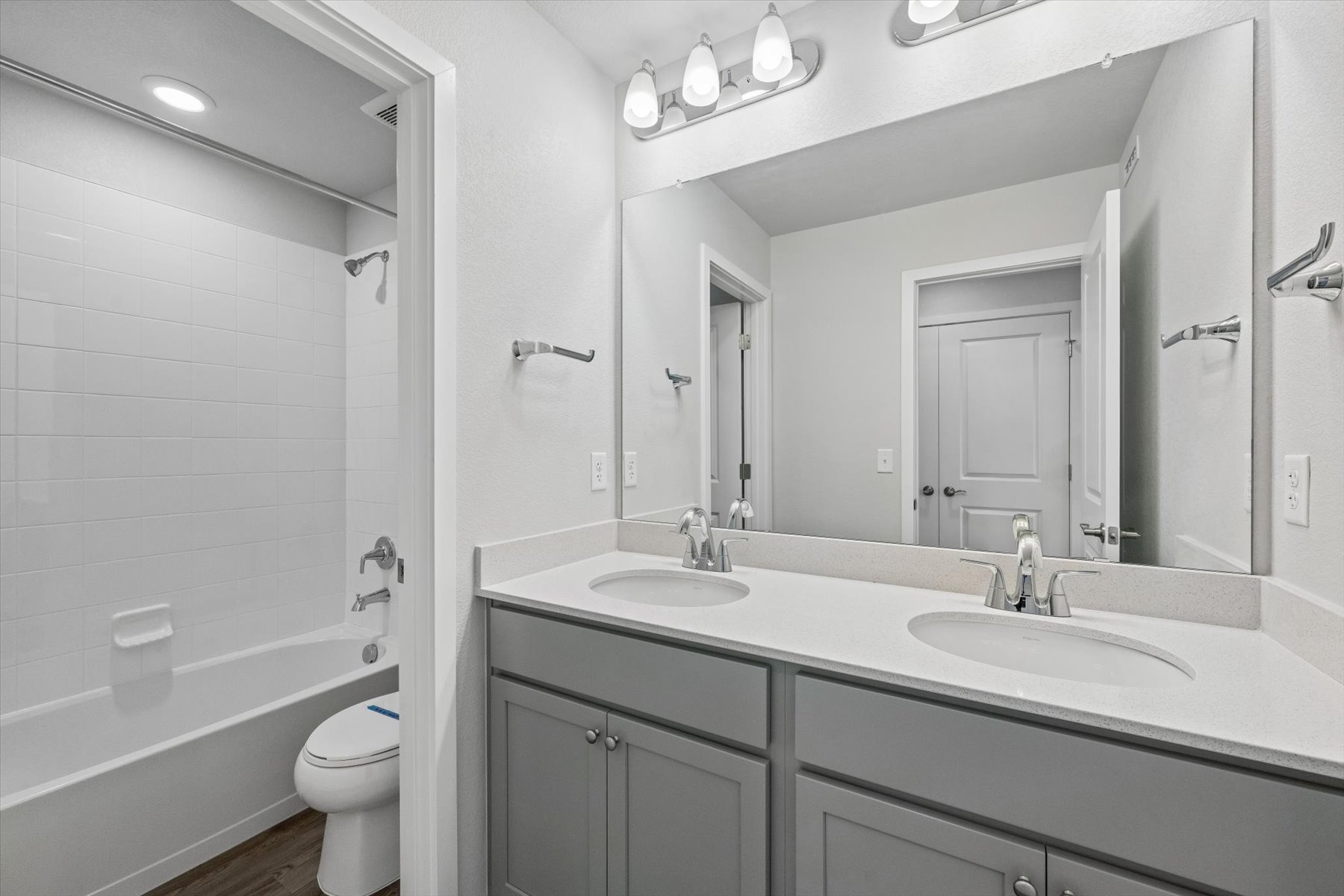 A bathroom with a tub sink and toilet.