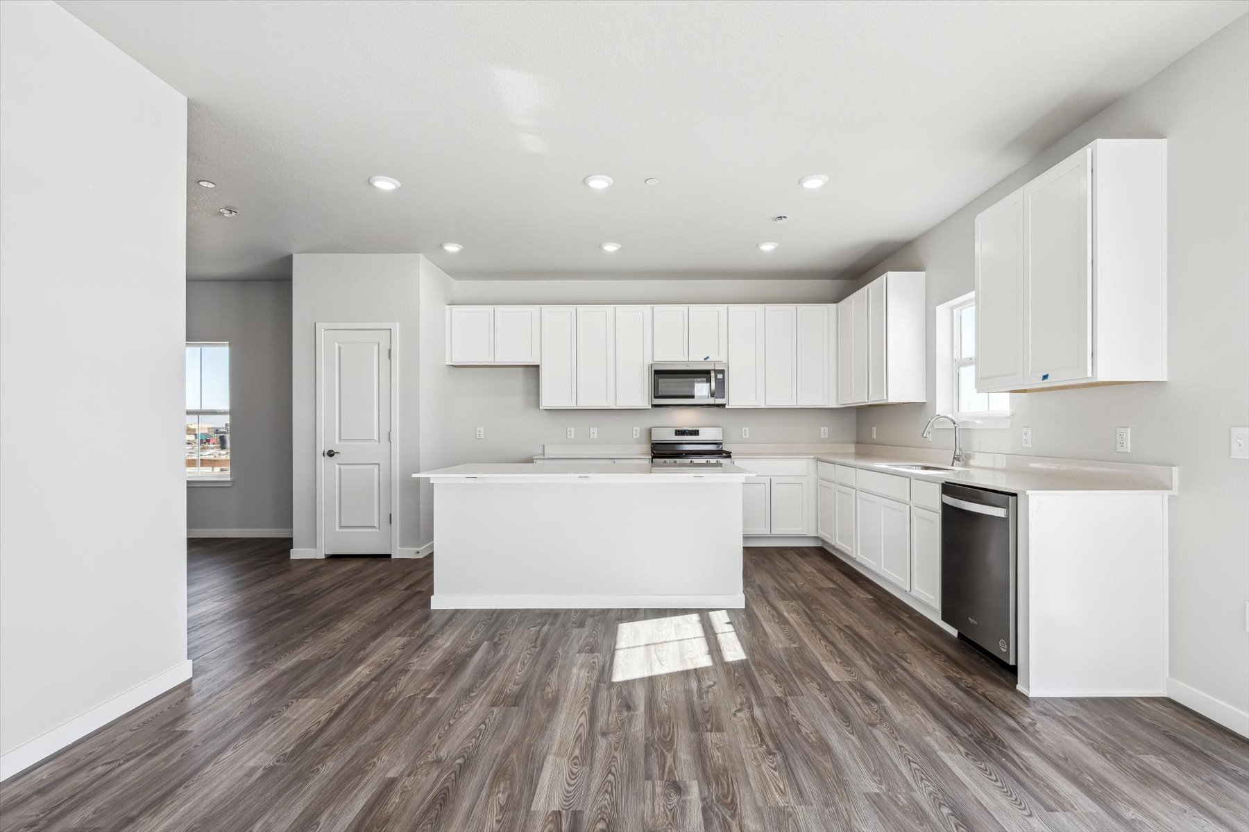 A kitchen with white cabinets.