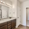 Owner's private bath with dual vanity and walk in closet of the ranch style Telluride plan by Century Communities