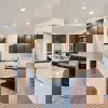 Open concept kitchen and hallway of the ranch style Telluride plan by Century Communities