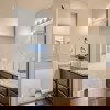 Owner's dual vanity and shower of the ranch style Telluride plan by Century Communities