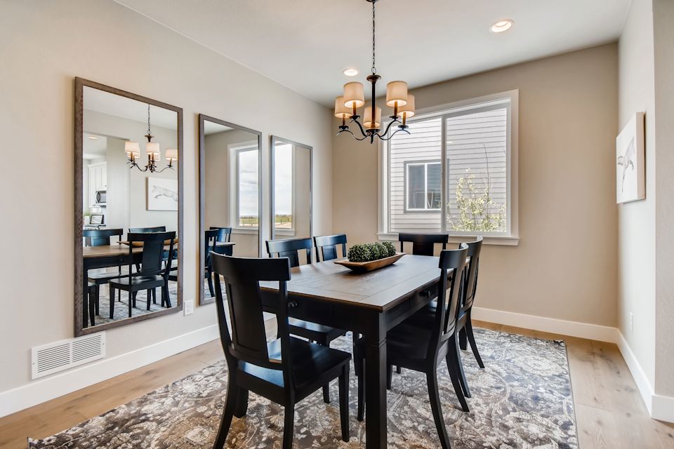 A dining room table with chairs.