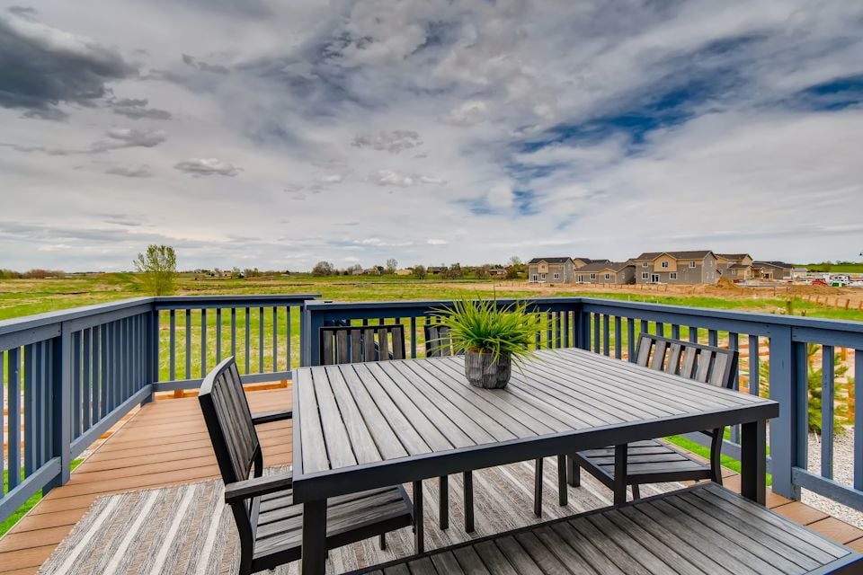 A table and chairs on a deck.