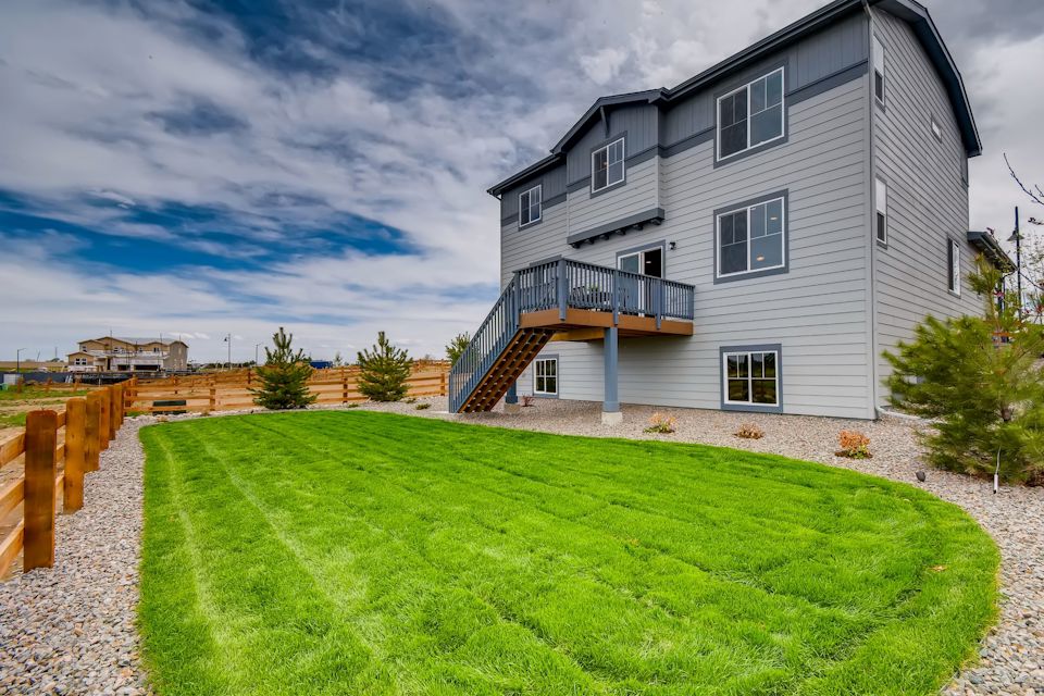 A building with a green lawn.