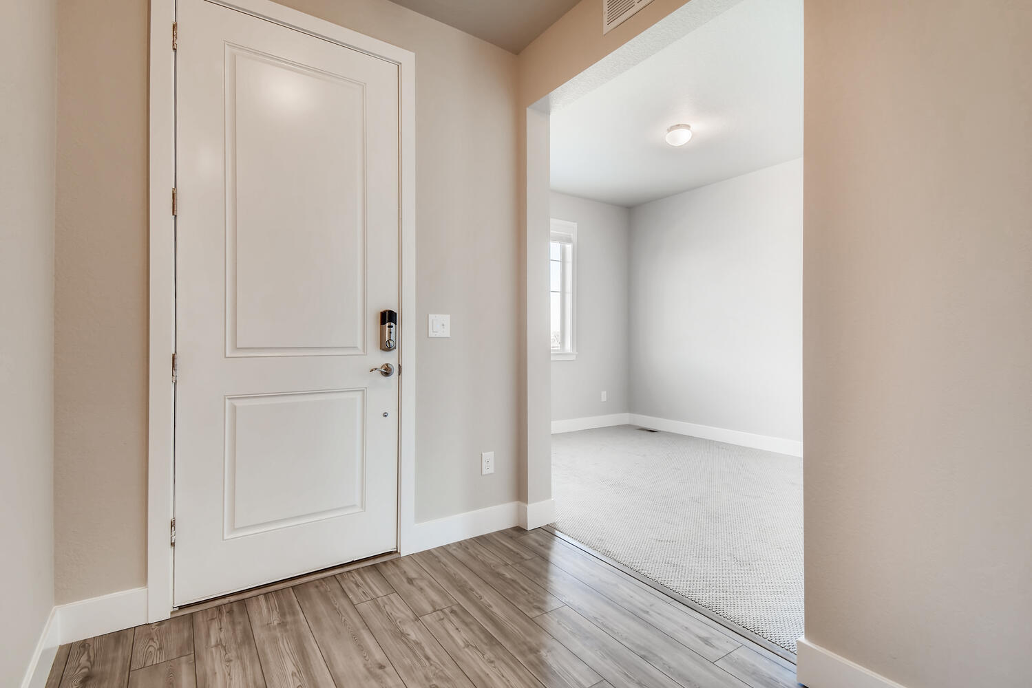 A room with a wood floor and white walls.