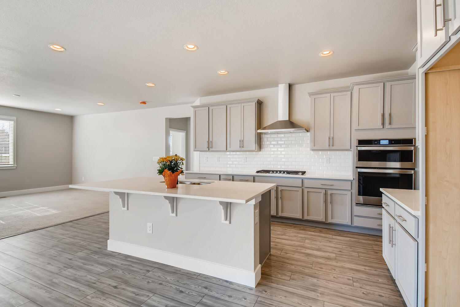 A kitchen with white cabinets.
