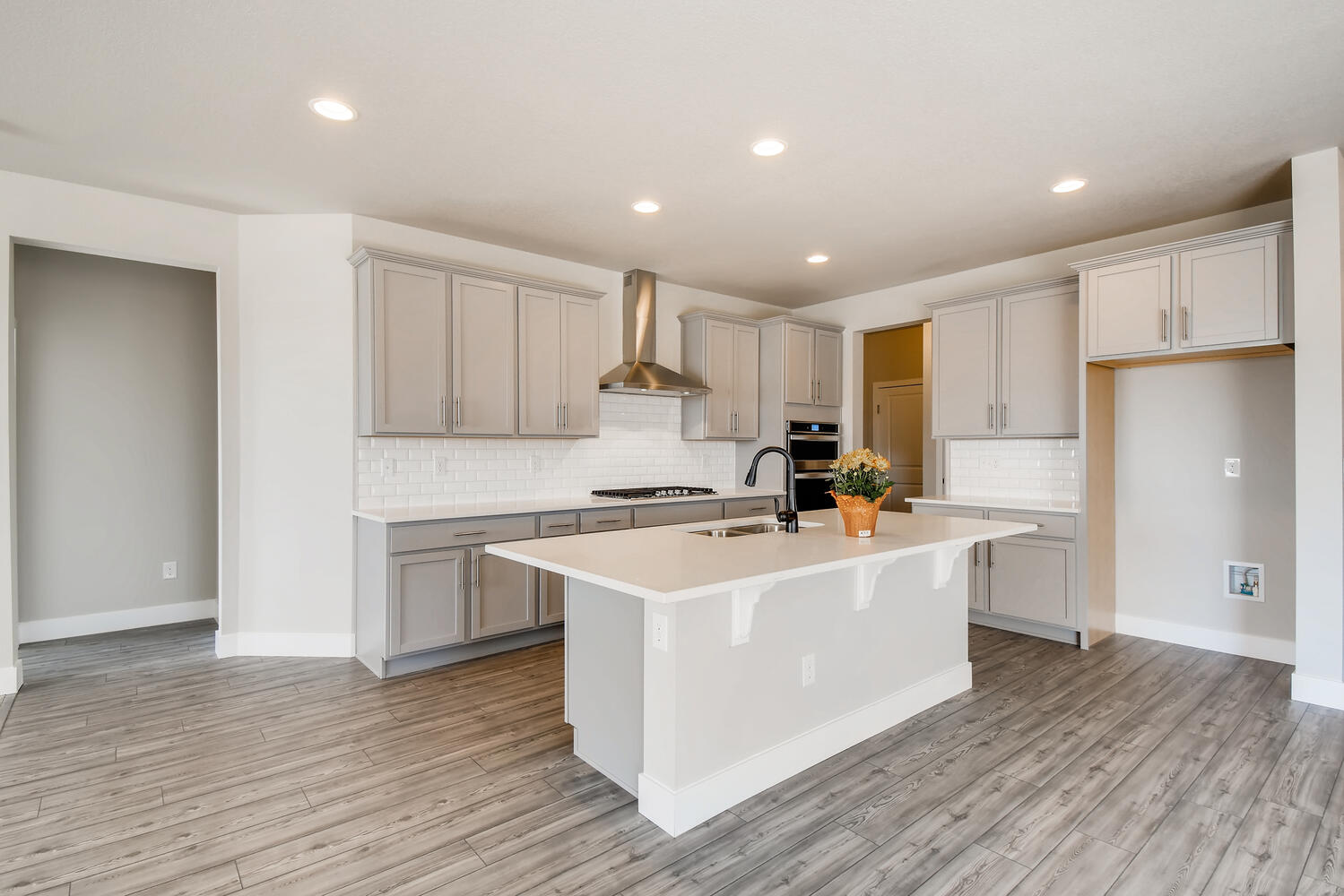 A kitchen with white cabinets.