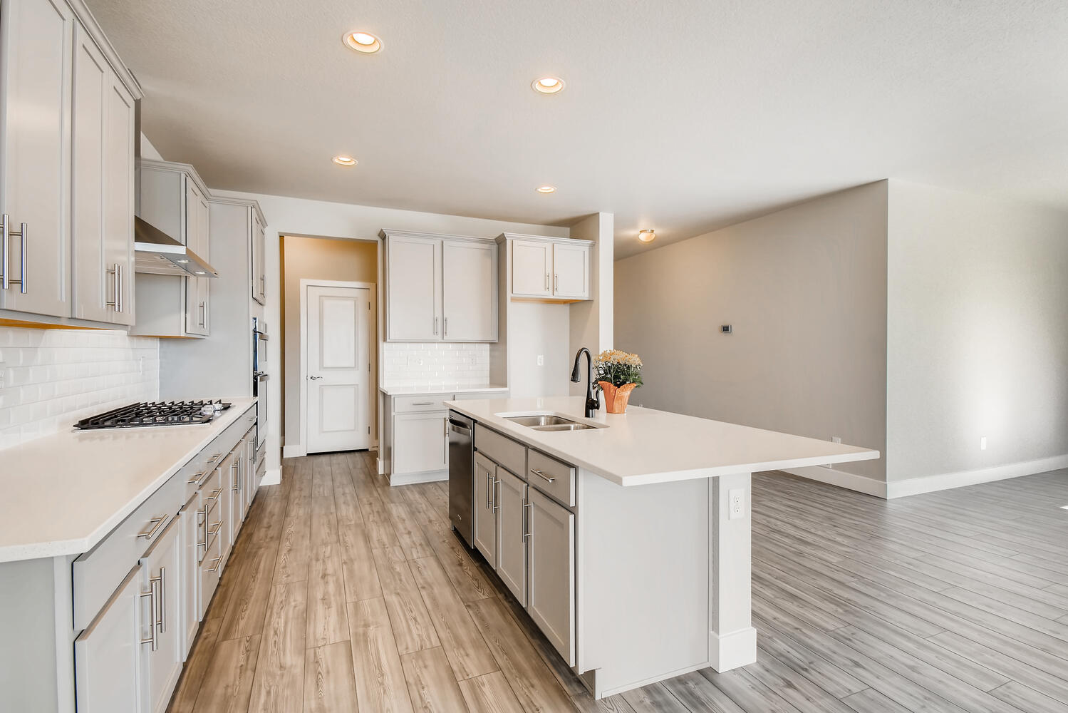A kitchen with white cabinets.