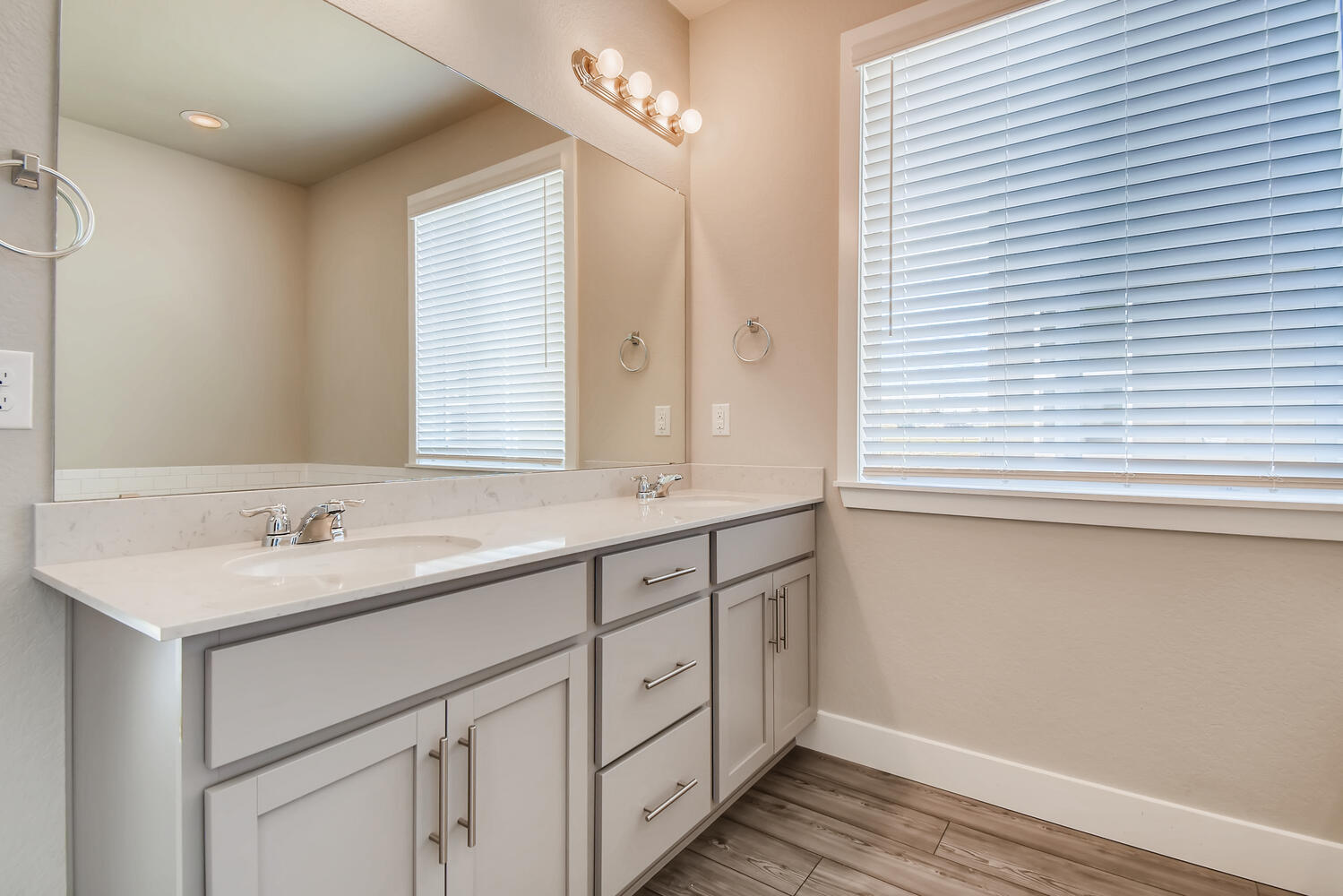 A bathroom with white cabinets.