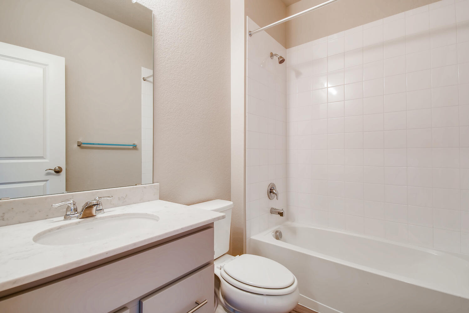 A bathroom with a sink toilet and bathtub.