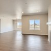 Great room and breakfast nook and fireplace of the ranch style Telluride plan by Century Communities