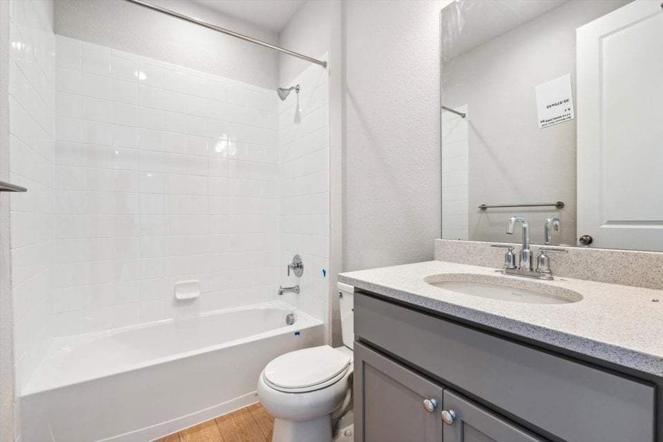 A bathroom with a tub sink and toilet.