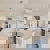 Kitchen island in Cornell II plan at The Outlook at Southshore by Century Communities