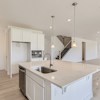 Kitchen island in Cornell II plan at The Outlook at Southshore by Century Communities