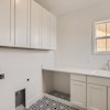 Upstairs laundry room in Cornell II plan at The Outlook at Southshore by Century Communities