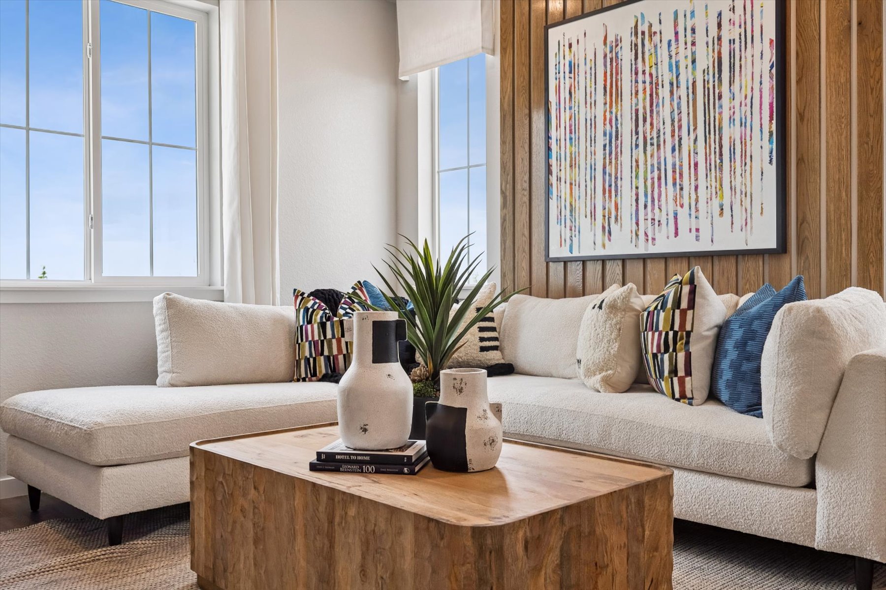 A living room with a white couch and a coffee table.