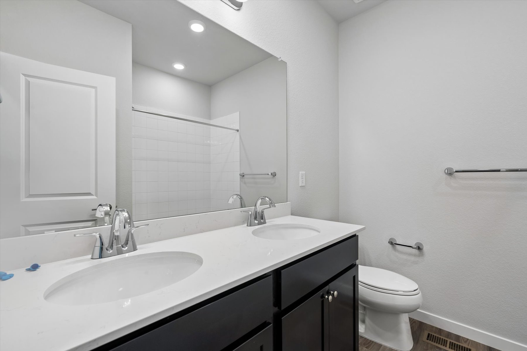 A bathroom with a large mirror.