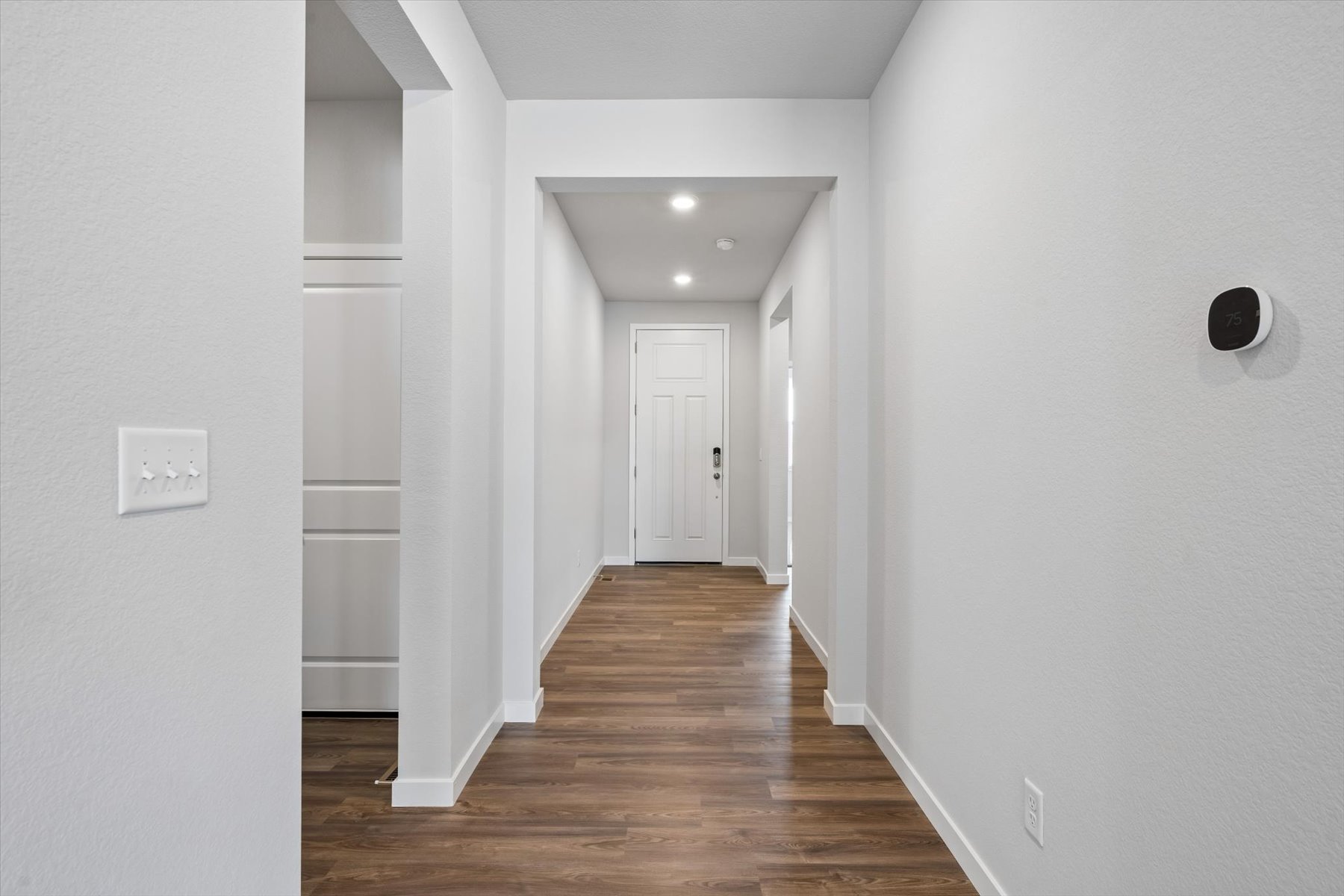 A hallway with white walls.