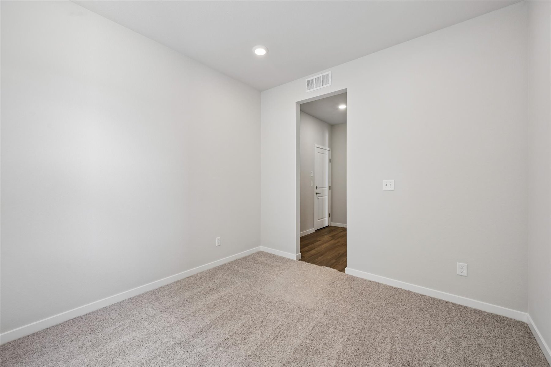 A hallway with a door.