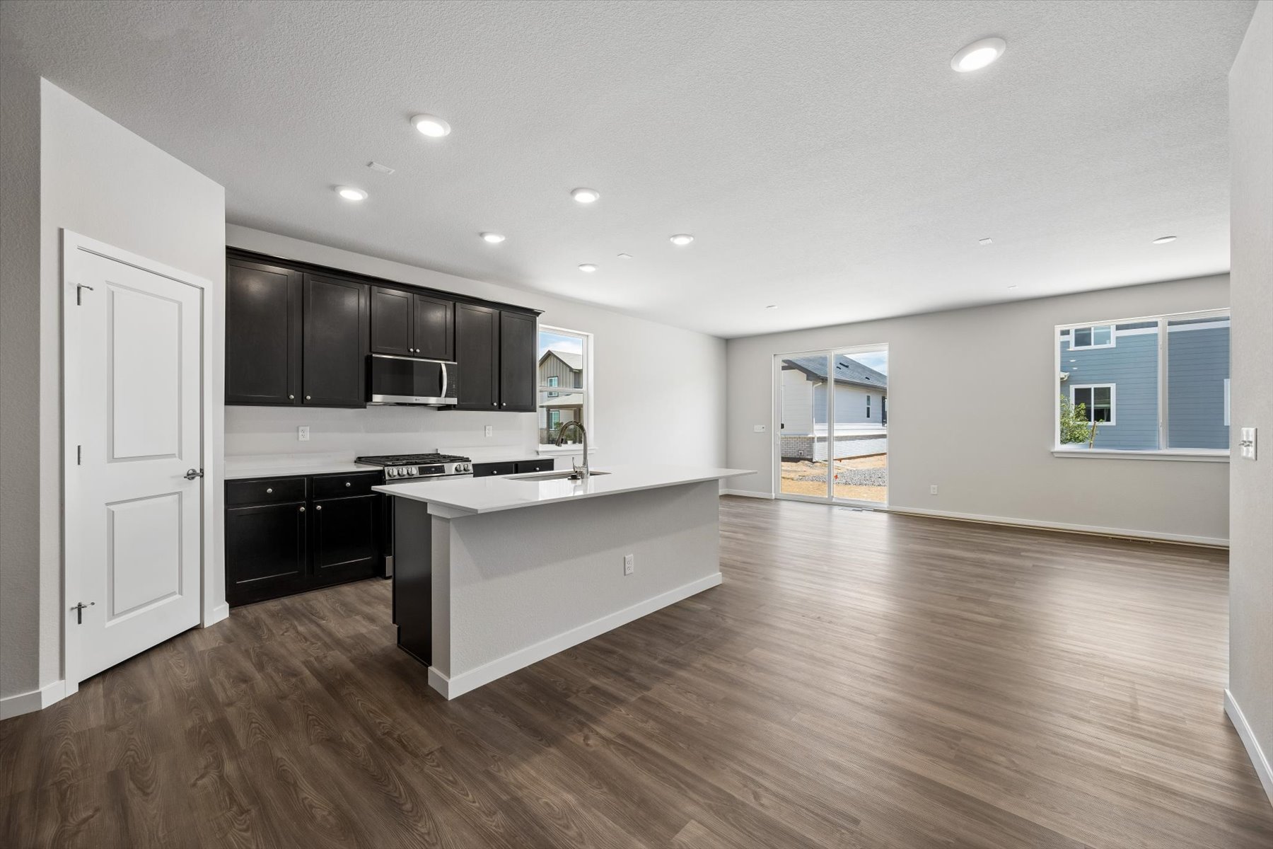 A large kitchen with black cabinets.