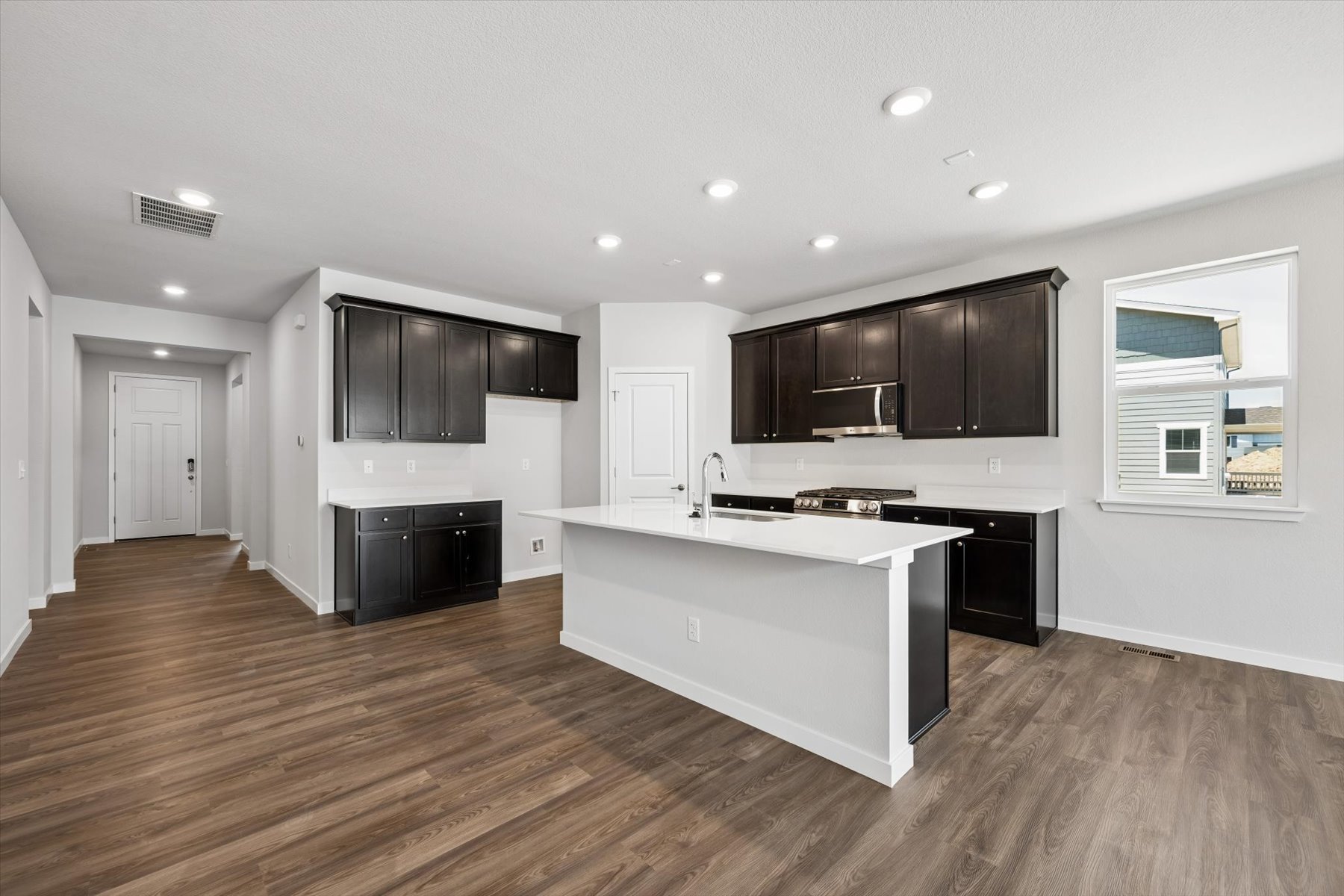 A kitchen with black cabinets.