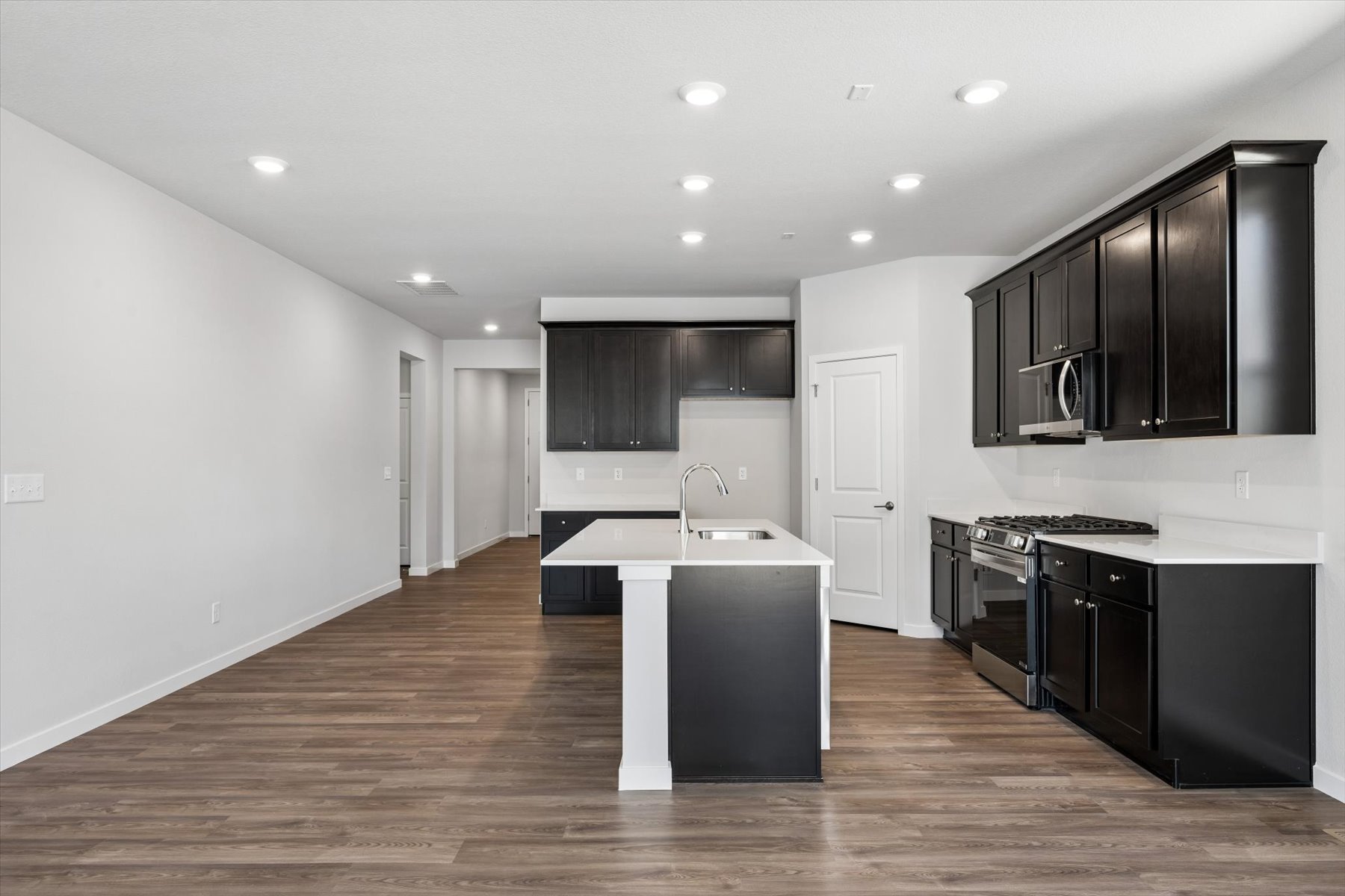 A kitchen with black cabinets.