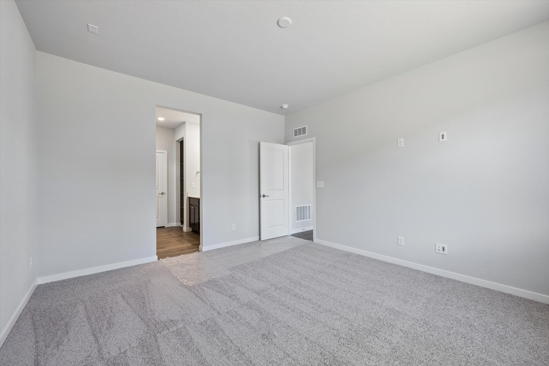 A long hallway with white walls.