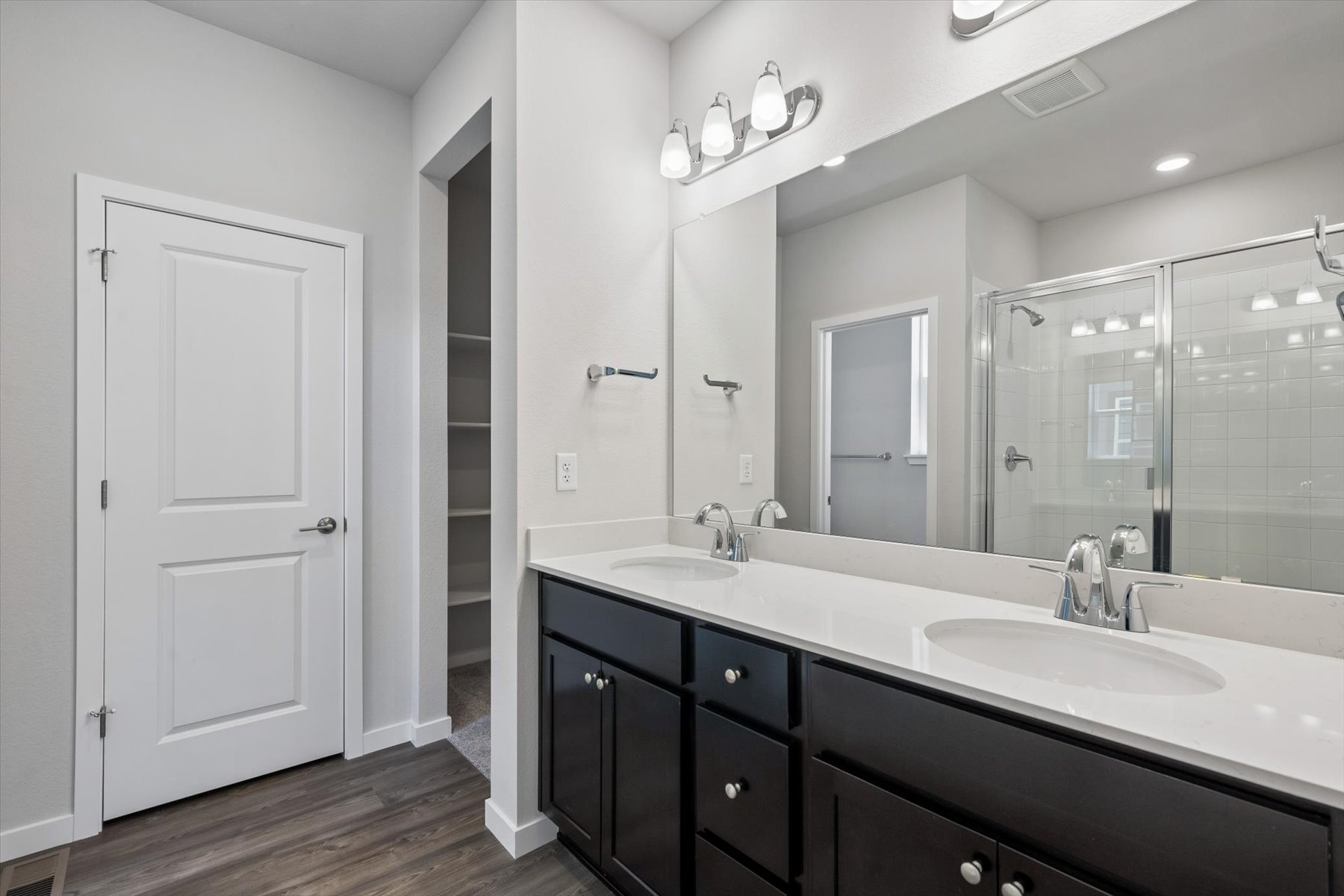 A bathroom with a large mirror.