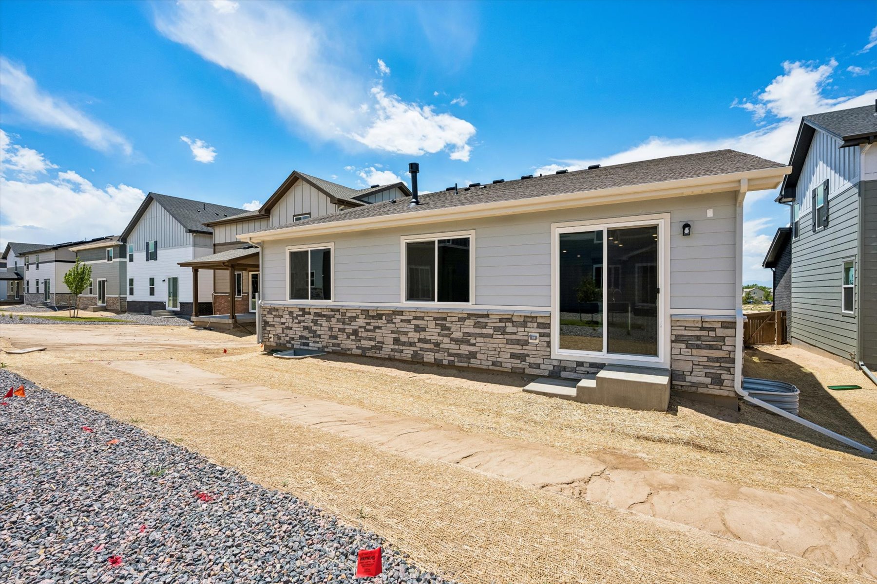 A house with a gravel driveway.