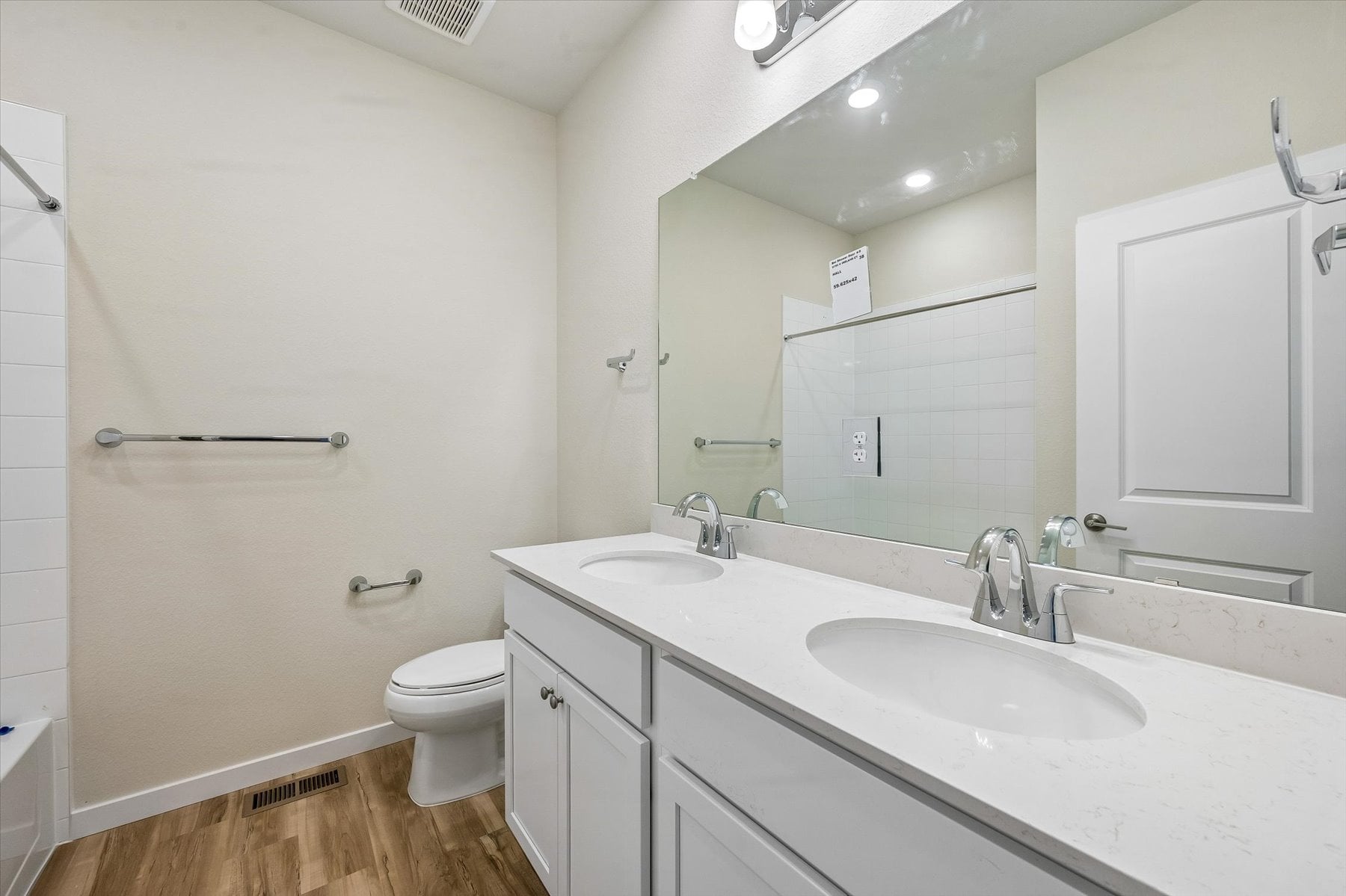 A bathroom with a large mirror.
