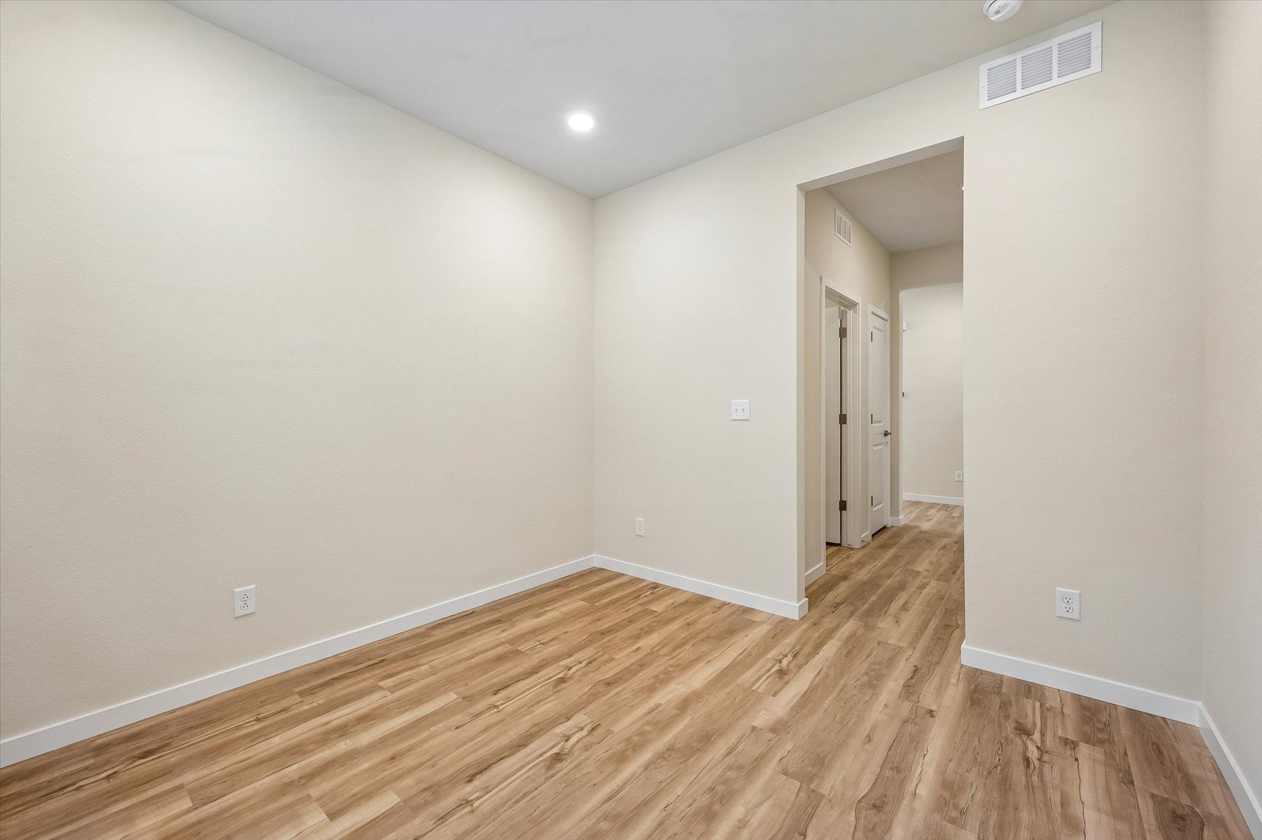 A room with a wood floor and a wood floor.