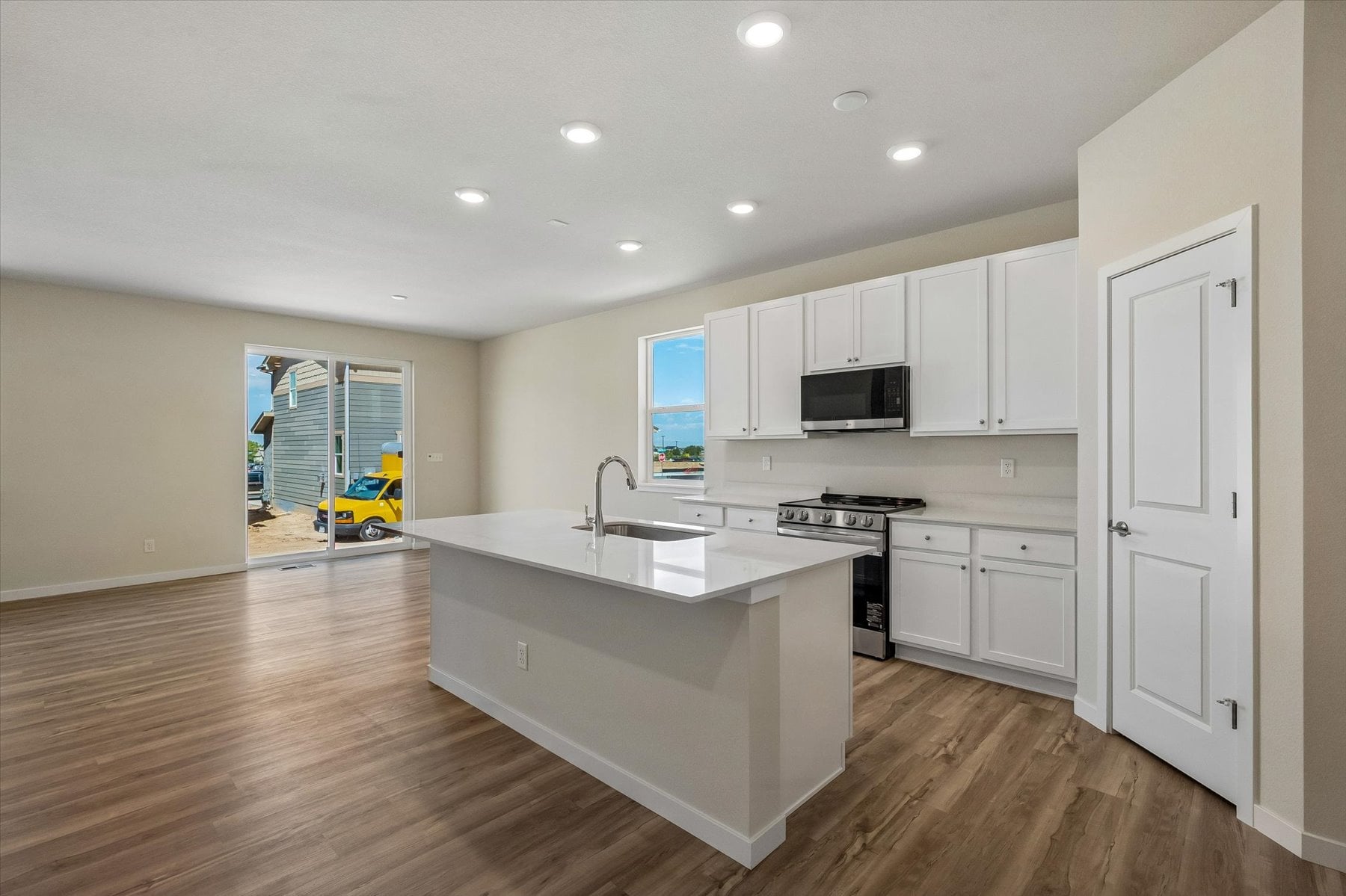 A kitchen with white cabinets.