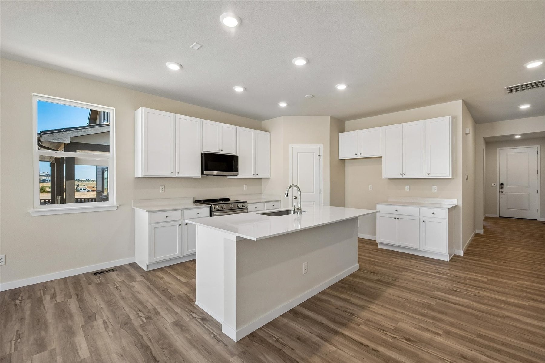 A kitchen with white cabinets.