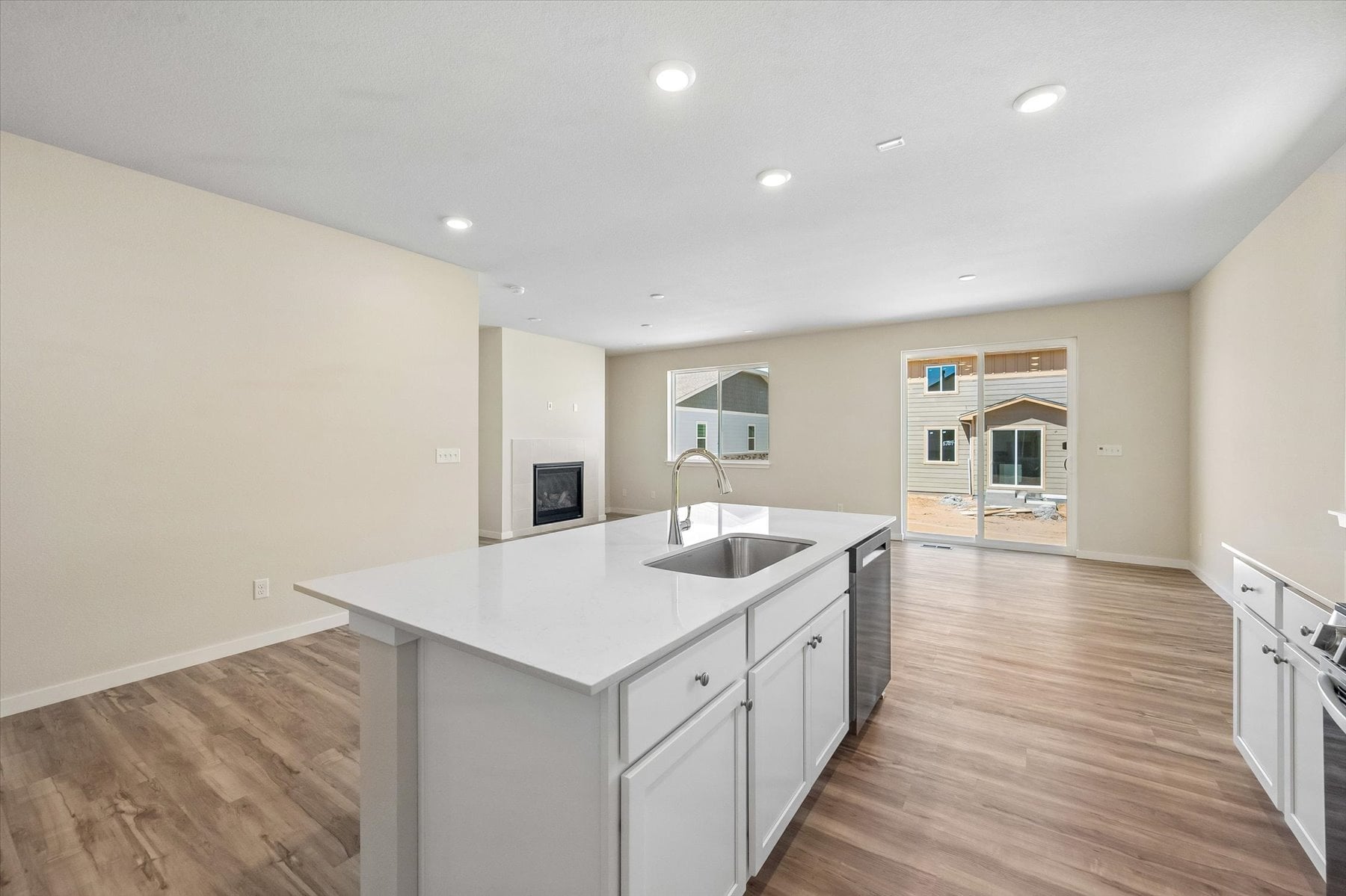 A kitchen with white cabinets.