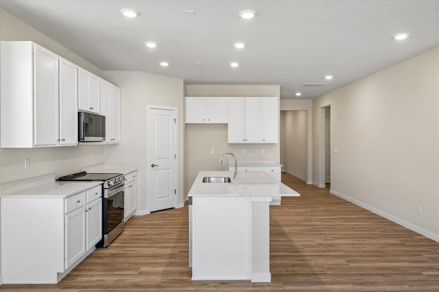 A kitchen with white cabinets.