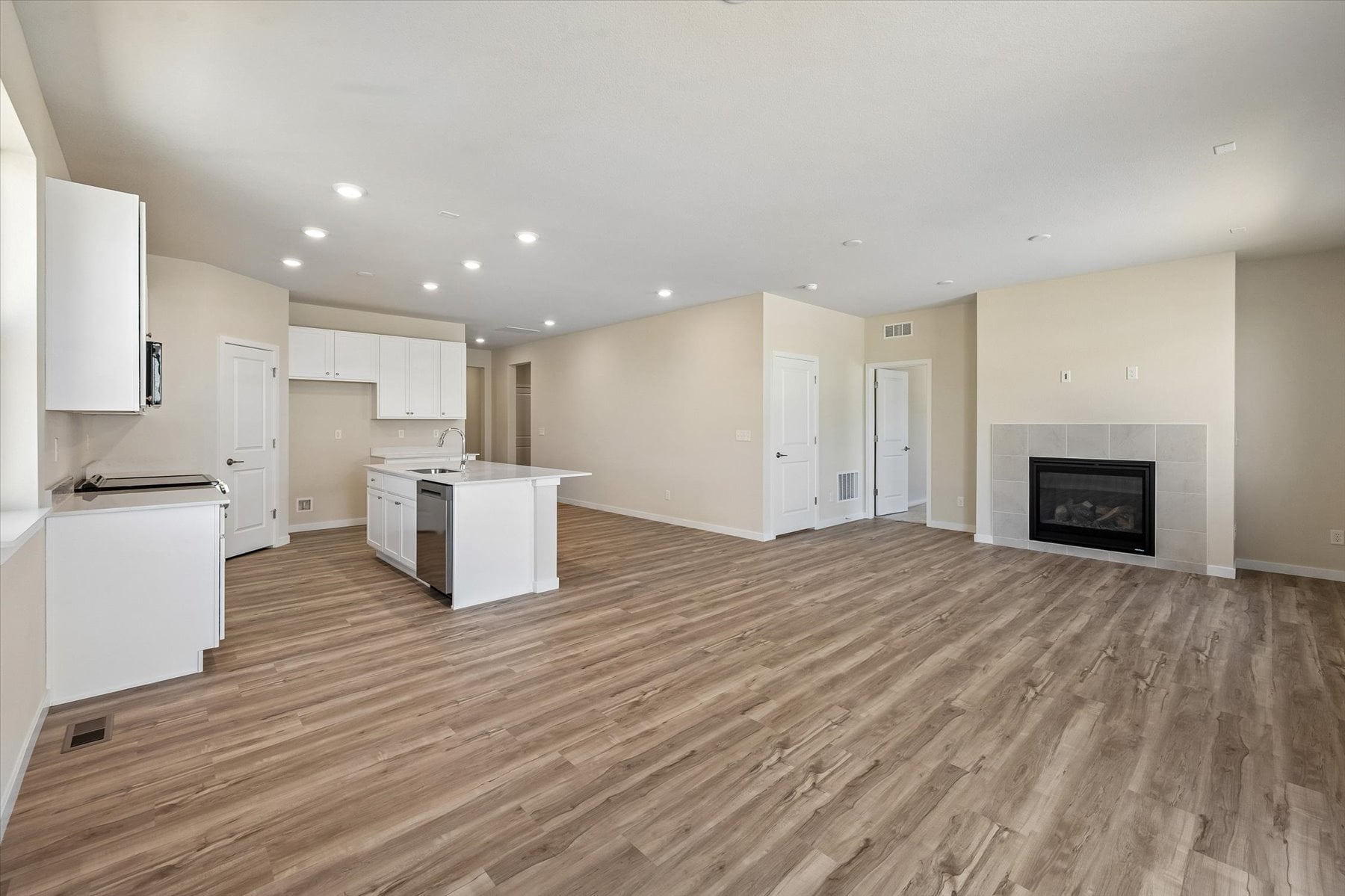A large kitchen with white cabinets.