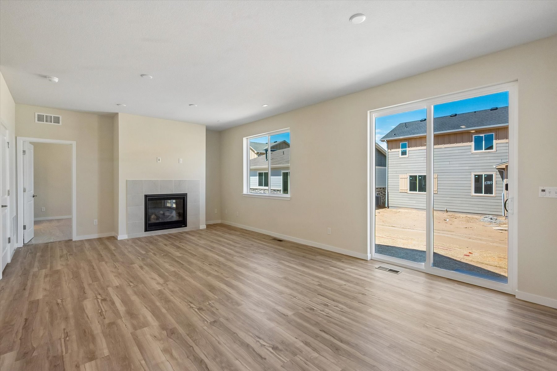 A room with a fireplace and a wood floor.