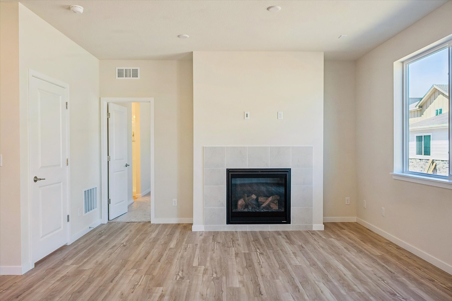 A room with white walls and a wood floor.