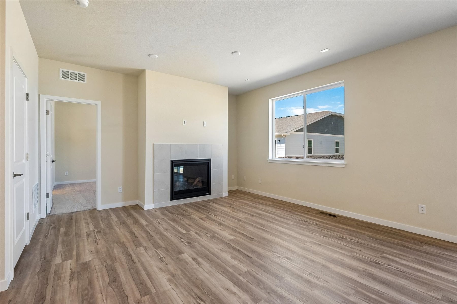 A room with a fireplace and a wood floor.