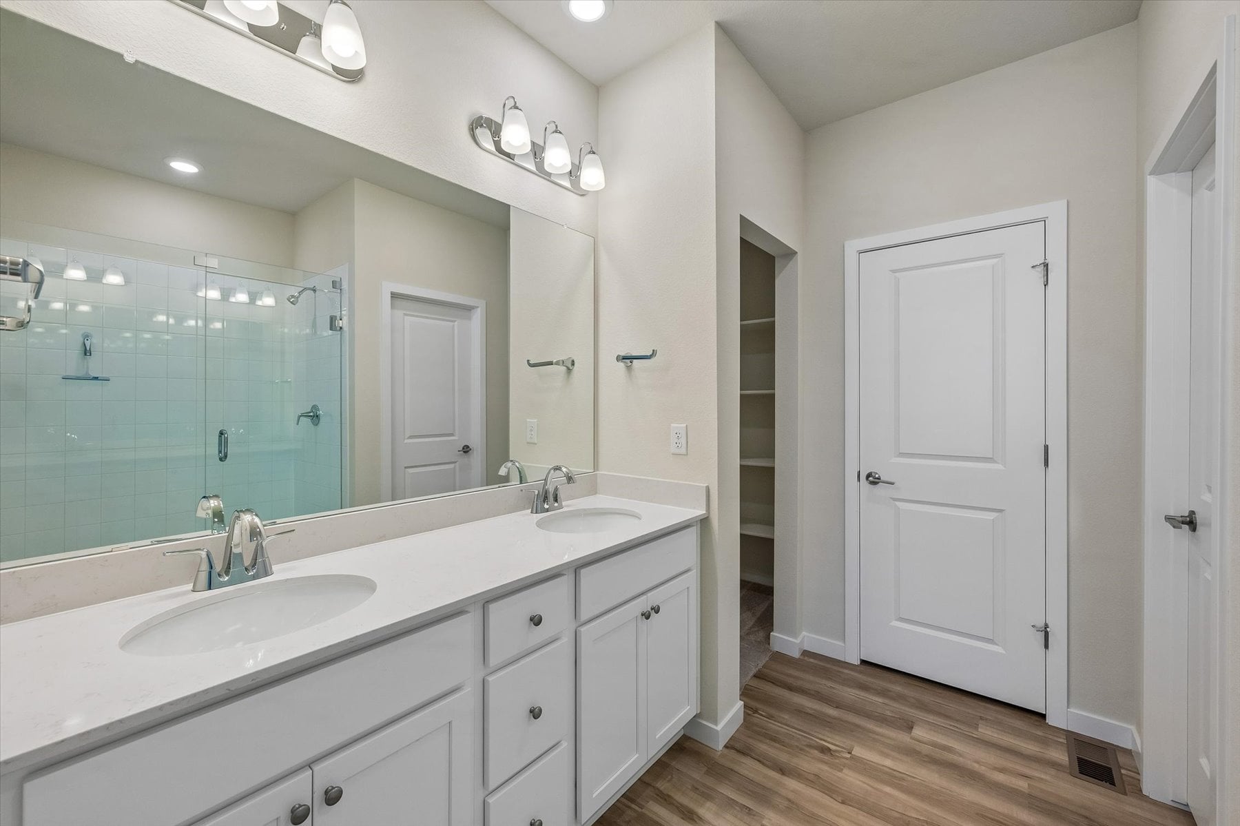 A bathroom with white cabinets.