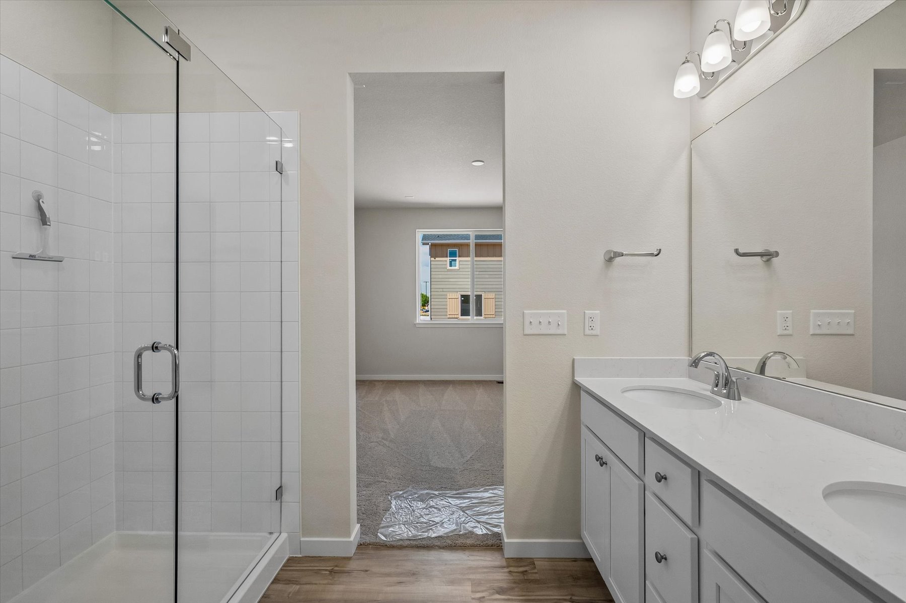A bathroom with a shower unit and sink.