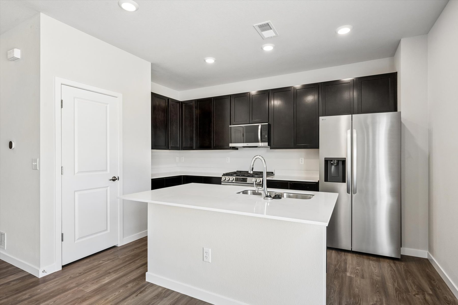 A kitchen with black cabinets.