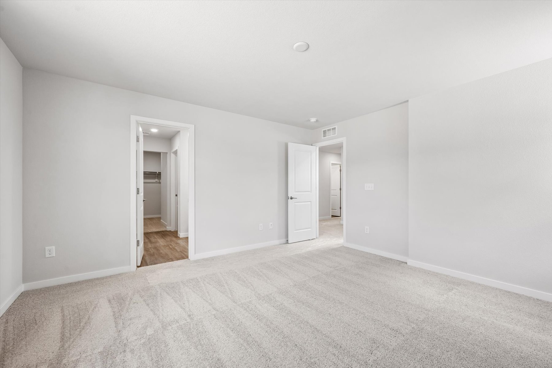 A long hallway with white walls.