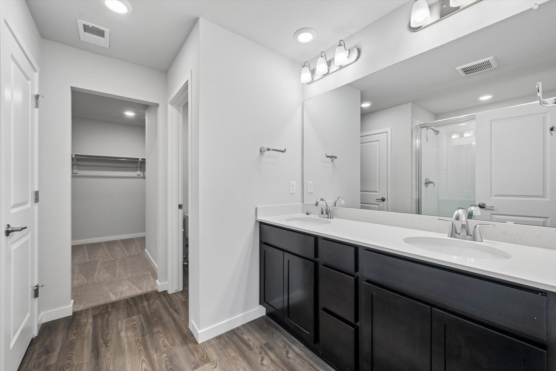 A bathroom with a large mirror.