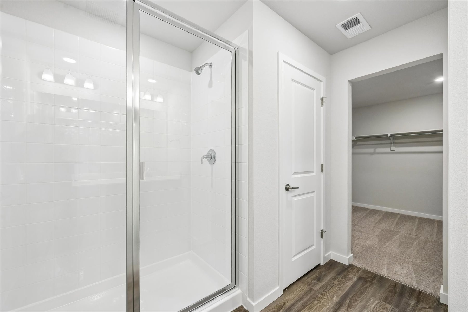 A bathroom with a shower unit and a shower unit.