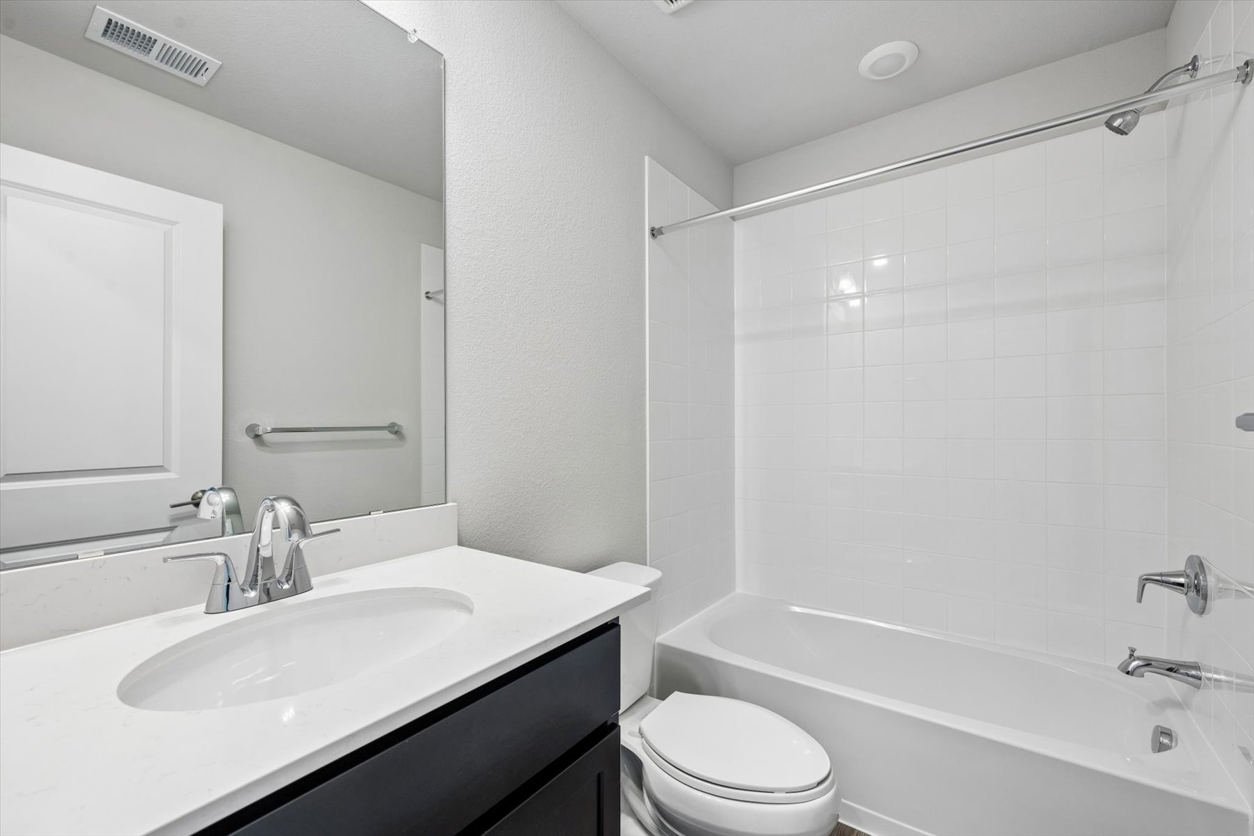 A bathroom with a tub sink and toilet.